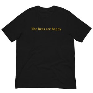 May include: Black t-shirt with the text "The bees are happy" printed in yellow.