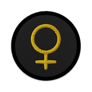 May include: A black and gold embroidered patch with a female symbol.