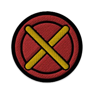May include: A red and yellow embroidered patch with a large X in the center. The X is yellow and the background is red with a black outline.