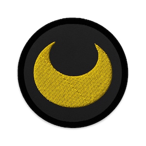 May include: A black and yellow embroidered patch with a crescent moon design.