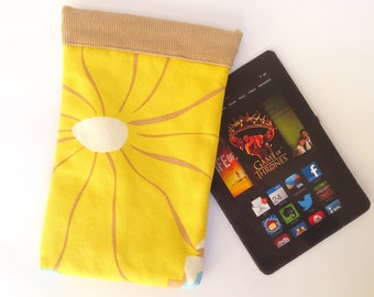 May include: A yellow fabric case with a brown corduroy top and a floral pattern. The case is designed to hold a tablet or e-reader. The case is lying on a white surface next to a black tablet with a screen displaying the Game of Thrones app.