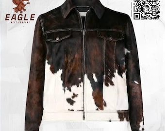 May include: A brown, black, and white cowhide jacket with a zip-up front, two chest pockets, and a collar. The jacket has a unique spotted pattern and is a statement piece. The brand logo "EAGLE NEXT COMPANY" is visible in the upper left corner.