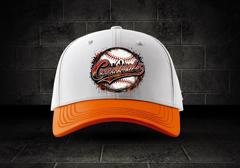 May include: A white baseball cap with an orange brim. The front features a graphic of a baseball with a red and black stylized script that reads Cardinals, surrounded by a distressed, paint-splatter effect in shades of red, black, and orange.