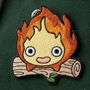 May include: A set of three ceramic mugs with a speckled, matte finish. The mugs are in shades of cream, light gray, and dark gray. Each mug has a simple, minimalist design and a rounded handle.