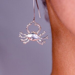 Silver crab pendant on thin sturdy chain. The pendant is detailed, showing the texture of the crab&#39;s shell and legs, Nautical gift for her