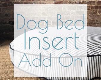 May include: A white and black striped round dog bed insert with a white border and black trim. The text "Dog Bed Insert Add On" is superimposed on the image.