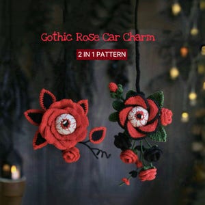 May include: Crocheted Gothic Rose car charm in red, black, and green. The charm features a red rose with an eyeball center and black leaves. The text "Gothic Rose Car Charm" and "2 IN 1 PATTERN" are visible.