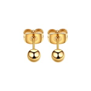 May include: A pair of gold-toned stud earrings with a small round ball at the end of each post.