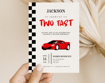 May include: A birthday invitation with the text "JACKSON IS GROWING UP TWO FAST". The invitation features a red race car graphic and a black and white checkered border. The invitation includes the date, time, and location of the party.