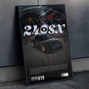 May include: A framed poster depicting a dark grey 240SX car with gold rims. The poster has the text "240SX" in a decorative font, and the years "1989-1994" and "S13". The background is dark, with an image of a car engine.