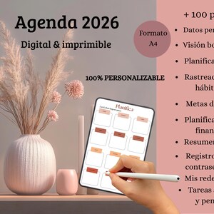 May include: A digital and printable 2026 planner with the text "Agenda 2026". The image shows a tablet with a planner layout, a vase with dried flowers, and a small pink candle holder. The planner is 100% customizable.