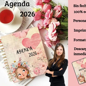 May include: A spiral-bound agenda for 2026 with a floral and heart design. The cover features the text "Agenda 2026" and an illustration of a girl. A cup of tea and a magazine are also visible.