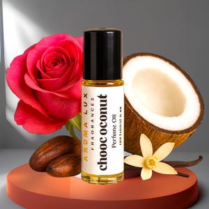 May include: A perfume oil bottle with a black cap and a label that reads "choc coconut". The bottle is surrounded by a red rose, a halved coconut, cocoa beans, a vanilla flower, and a vanilla bean. The product is on a red platform.