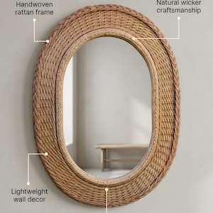 May include: An oval mirror featuring a handwoven rattan frame with natural wicker craftsmanship. The wall decor has an artisan handmade design. Text on the image includes: Handwoven rattan frame, Natural wicker craftsmanship, Lightweight wall decor, Artisan handmade design.