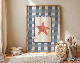 May include: A framed print featuring a cartoon starfish with a smiling face. The starfish is coral-colored with white spots, set against a cream background with a scalloped border. The frame has a blue and white checkered pattern.