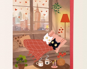 May include: A greeting card illustration featuring a white cat and a black cat resting under a red plaid blanket on a sofa. The scene includes a window with a city view, floating red hearts, a floor lamp, two mugs, candles, and potted plants.
