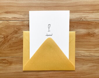 Cheers Champagne Glass Letterpress Card - Enkele kleur met gouden stof envelop en blanco interieur