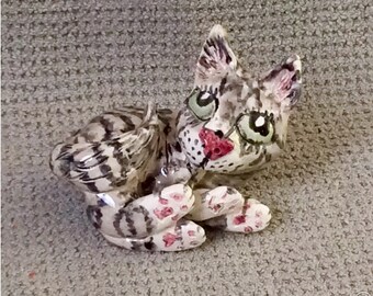 Sweet little tabby ready for adoption .