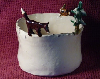 Fox chasing rabbit bowl notice the rabbit tracks. Handmade in U.S. from a lump of clay