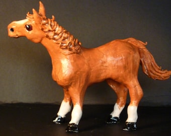 Red Horse sculpture handmade from a lump of clay in USA