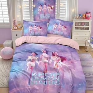 May include: A K-Pop themed bedding set with a duvet cover, two pillowcases, and a decorative pillow. The set features a purple and pink colour scheme with illustrations of three female figures and the text "KPOP DEMON HUNTERS".