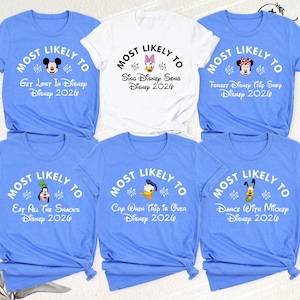 May include: Six t-shirts with the phrase "Most Likely To" and Disney-themed text and characters. The shirts are light blue or white, with black text and character graphics. The text includes "Get Lost In Disney," "Sing Disney Song," and "Forget Disney Trip Shop." The year 2020 is also printed.