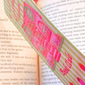 side view of the bookmark, size is wider at 3.5 inches by 6.5 inches, image is on both sides on thick paper with clear laminate