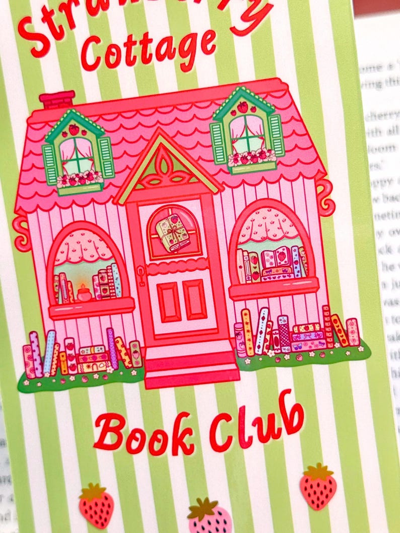 Illustration of a whimsical pink cottage labeled "Strawberry Cottage Book Club," adorned with books, strawberries, and green striped background.