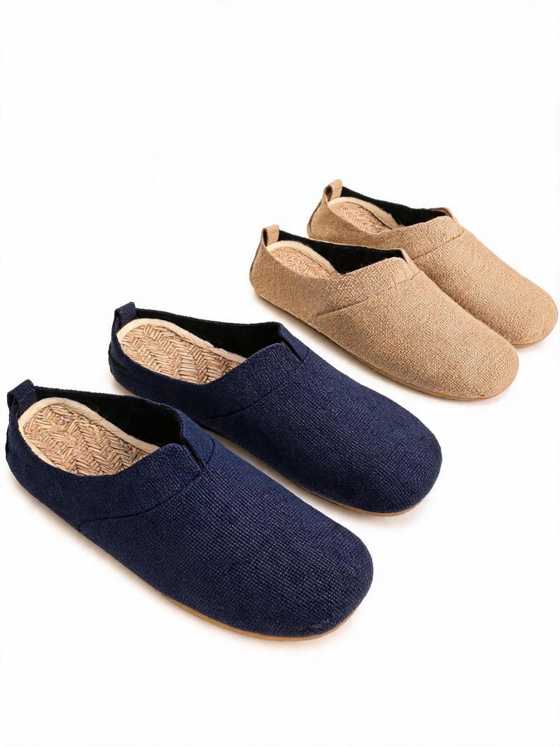 May include: Three slip-on shoes with textured fabric uppers in navy blue and tan. Each shoe features a rounded toe, a low-cut collar with black interior lining, and a woven straw-like insole. The design is simple and lacks laces or fasteners.