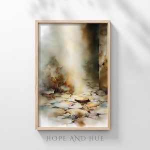 Op de afbeelding: Een ingelijste aquarelprint met een abstract landschap in zachte beige, bruine en grijze tinten. Een cirkelvormig object ligt op een stenen pad. De tekst "HOPE AND HUE" is onderaan zichtbaar.