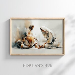 May include: Watercolor print in a light wood frame depicts a biblical scene. Two figures are shown, one seated and the other kneeling, with soft, muted colors. The text "HOPE AND HUE" is at the bottom of the image.