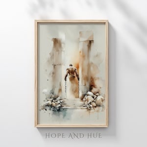 May include: A framed watercolour print featuring a muscular figure walking away, holding chains, between two columns. The artwork uses a soft palette of beige, brown, and grey. The text "HOPE AND HUE" is at the bottom of the print. The frame is light wood.