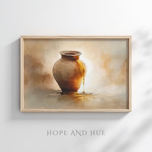 May include: A framed art print depicts a brown earthenware pot with a liquid pouring from it. The artwork has a warm color palette with shades of brown, gold, and beige. The text "HOPE AND HUE" is printed at the bottom of the frame.