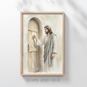 May include: A framed watercolor print depicts a figure in white robes and a gray shawl knocking on a wooden door. The door is set in a stone archway. The text "HOPE AND HUE" is at the bottom of the frame.