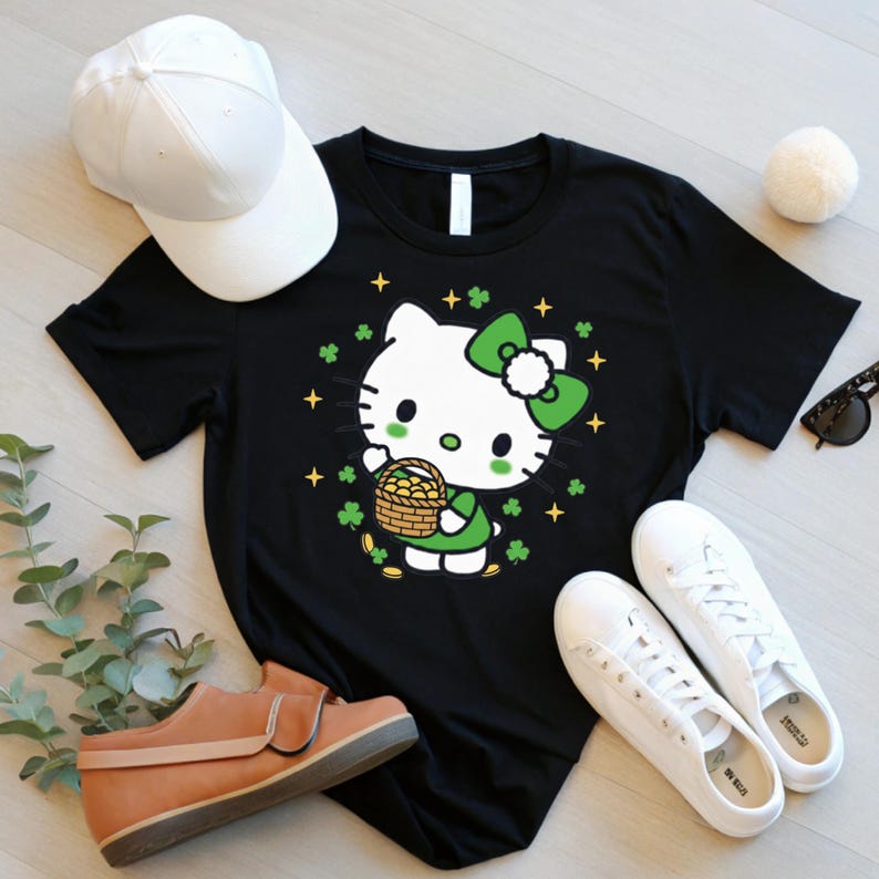 May include: Black t-shirt featuring a cartoon character with a green bow, holding a basket of gold coins, surrounded by shamrocks and stars. A white baseball cap, brown shoes, and white sneakers are also in the image.