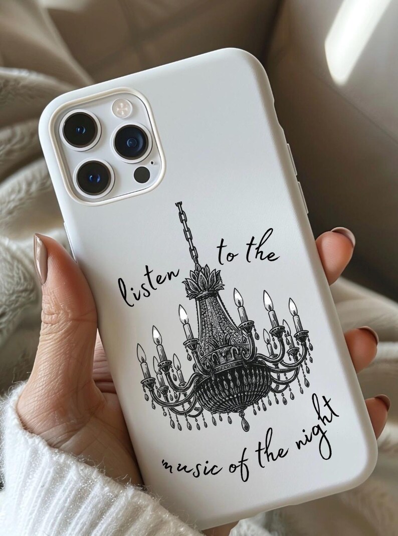 May include: White phone case featuring a black chandelier design with the text "listen to the music of the night." The case has a glossy finish and a protective bumper around the edges.