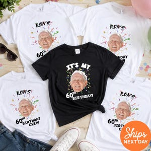May include: A collection of short-sleeved t-shirts in white and black featuring a custom photo of a man's face surrounded by colorful confetti graphics. The text reads Ron's 60th Birthday or It's My 60th Birthday, with some shirts labeled 60th Birthday Crew.