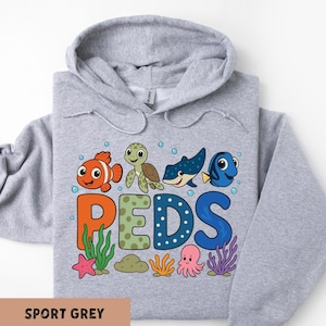 A grey hoodie with a colorful graphic design featuring cartoon sea animals and the letters 'PEDS' arranged in a playful manner.