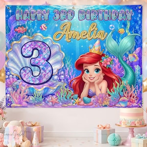 May include: A rectangular birthday banner featuring an underwater scene with a mermaid, a large seashell, and the text HAPPY 3RD BIRTHDAY Amelia. The design includes a large number 3, colorful coral, bubbles, and fish against a blue background.