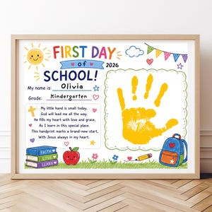 May include: A framed First Day of School 2026 sign featuring a yellow handprint, a stack of books labeled Faith, Love, and Learn, a red apple, and a blue backpack. The text includes My name is Olivia, Grade Kindergarten, and a religious poem.