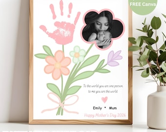 May include: A framed print featuring a handprint and a photo of a mother and child. The print includes a floral bouquet design with the text "To the world you are one person to me you are the world." The words "Happy Mother's Day 2026" are also included.