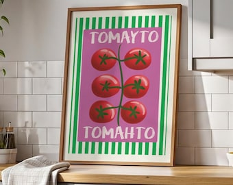 May include: A framed print featuring a cluster of red tomatoes on a pink background, with the word "TOMAYTO" above and "TOMAHTO" below. The print has a green and white striped border and is displayed in a kitchen setting.