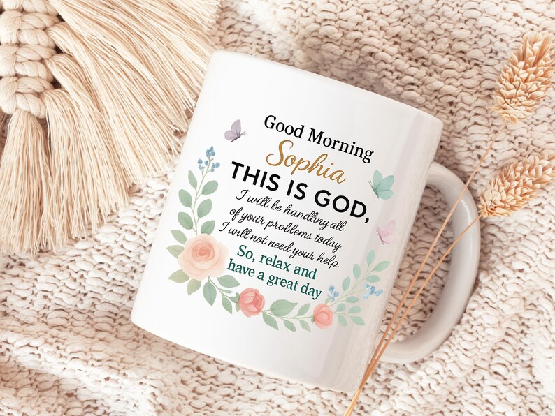 Personalized Christian coffee mug with pastel floral wreath on white ceramic; reads 'Good Morning Sophie' with a gold handle.