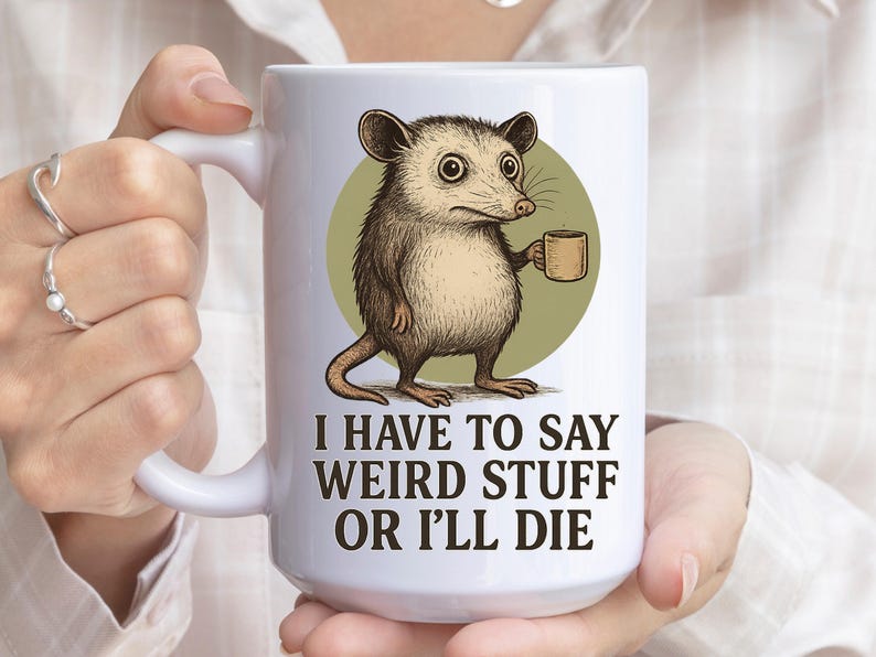 Funny possum mug featuring a cartoon possum holding a cup with a weird stuff quote; quirky office humor mug, coworker gift.