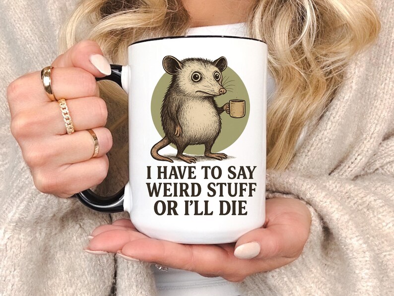 Funny possum mug featuring a cartoon possum holding a cup with a weird stuff quote; quirky office humor mug, coworker gift.