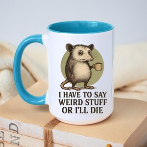 Funny possum mug featuring a cartoon possum holding a cup with a weird stuff quote; quirky office humor mug, coworker gift.