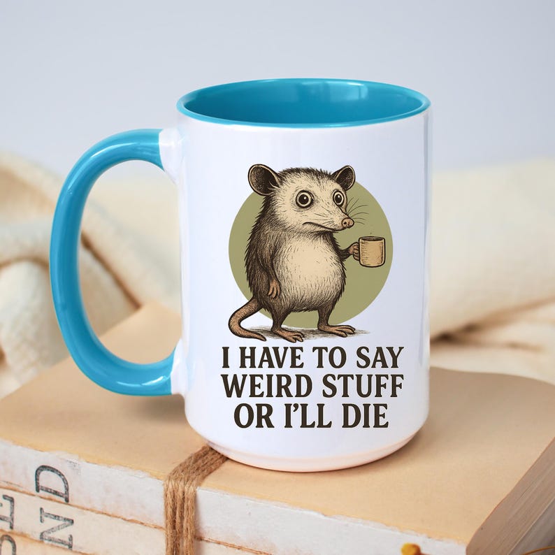 Funny possum mug featuring a cartoon possum holding a cup with a weird stuff quote; quirky office humor mug, coworker gift.