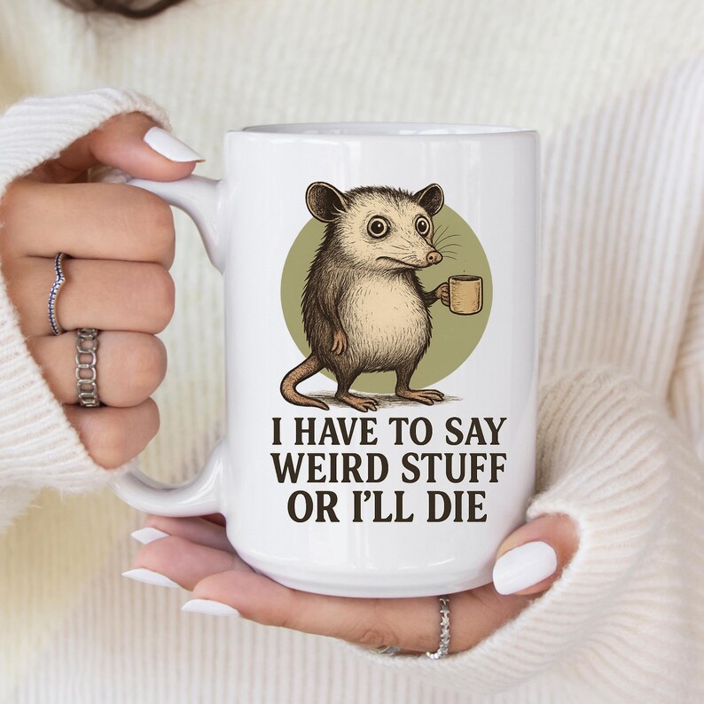 Funny possum mug featuring a cartoon possum holding a cup with a weird stuff quote; quirky office humor mug, coworker gift.