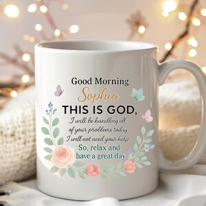 Personalized white ceramic christian coffee mug with gold name Sophia, pastel floral border, good morning Bible verse style text.