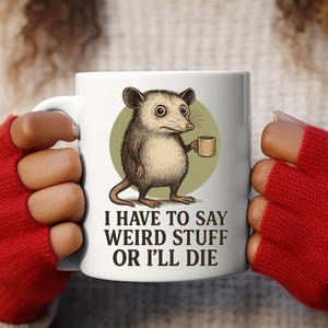 Funny possum mug featuring a cartoon possum holding a cup with a weird stuff quote; quirky office humor mug, coworker gift.